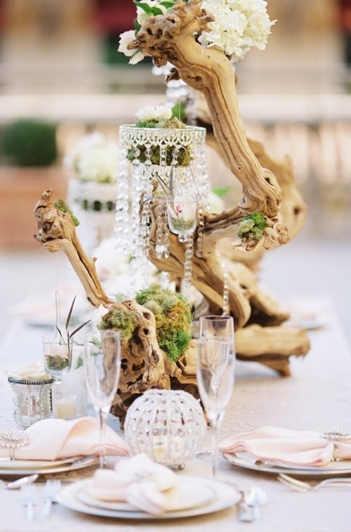 a beach driftwood wedding centerpiece with moss, neutral blooms, crystals is amazing for a beach or coastal wedding