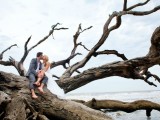 take your wedding portraits on large pieces of driftwood and branches on the beach to embrace to location