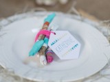 a bit of color block driftwood to mark each place setting for a beach boho wedding