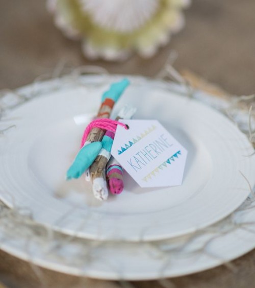 a bit of color block driftwood to mark each place setting for a beach boho wedding