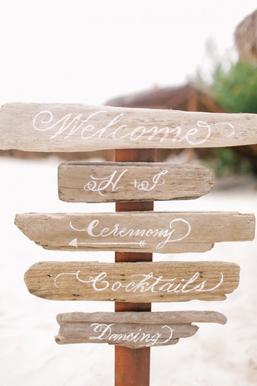 wedding signage made of driftwood is a cool idea for a coastal wedding, it's a very eco-friendly idea