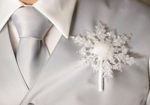 a frosty white snowflake boutonniere is a lovely idea for a winter wedding, it will add a bit of winter feel to the space