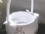 a white basket decorated with silver snowflakes is a lovely idea for a flower girl in winter