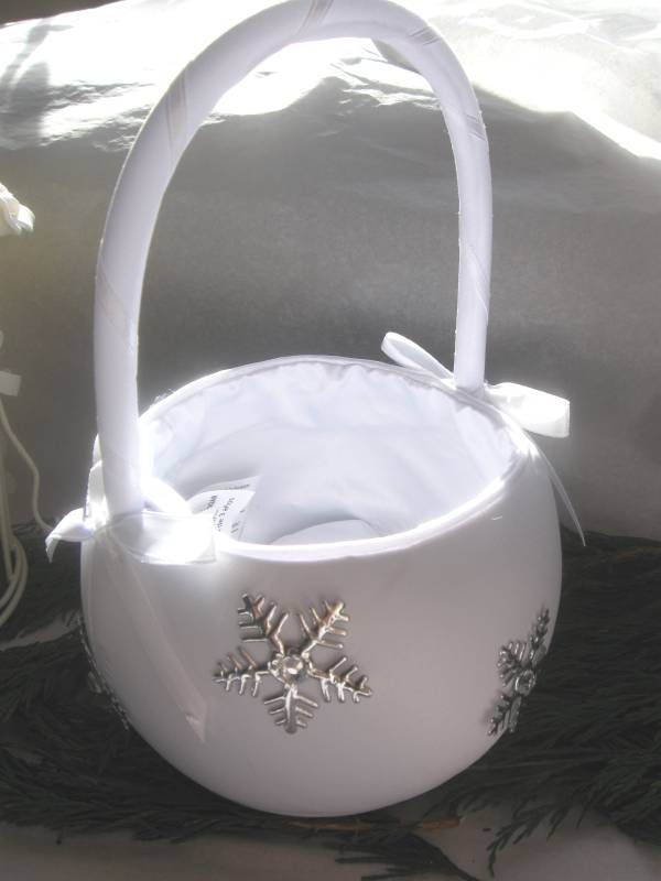 A white basket decorated with silver snowflakes is a lovely idea for a flower girl in winter