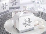 a white box with a cutout snowflake is a lovely idea for packing a favor during a winter wedding
