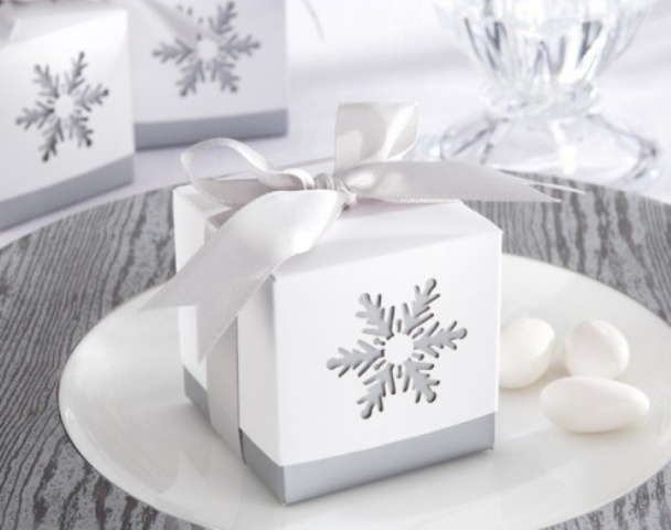 A white box with a cutout snowflake is a lovely idea for packing a favor during a winter wedding