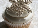 a cupcake topped with a silver snowflake topper is a fantastic idea for a winter wedding, it will add glam and interest to your dessert table