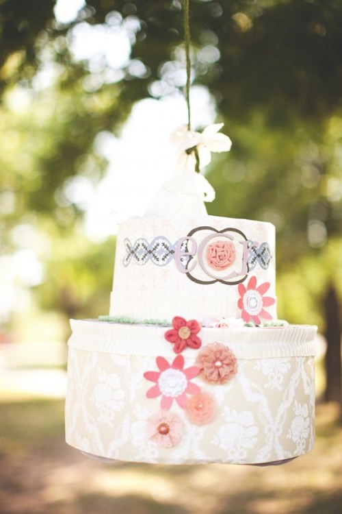 a bold wedding cake pinata guest book with prints, floral appliques is a unique idea to make your wedding bolder
