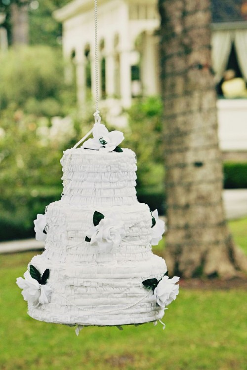 a  white and black fringe cake-shaped pinata wedding guest book is a gorgeous idea for a refined wedding and it will add a lot of fun