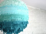 a turquoise ombre fringe pinata wedding guest book is a lovely and bold idea for a colorful modern wedding