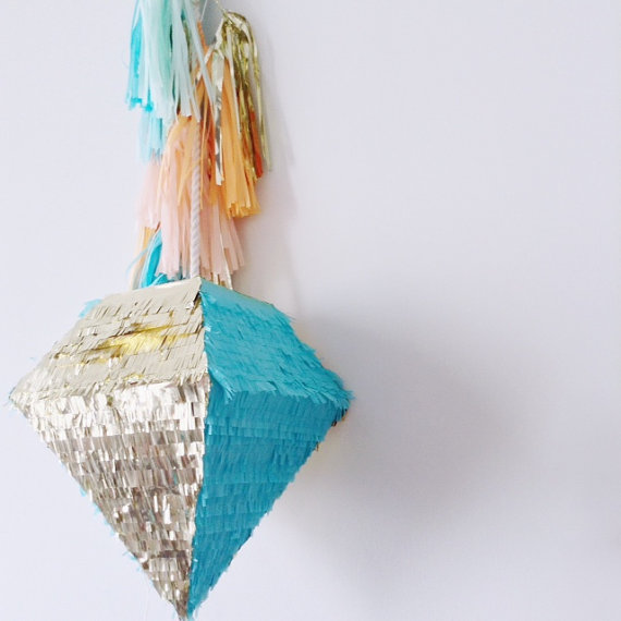A beautiful and bold turquoise and silver fringe diamond shaped pinata wedding guest book with colorful tassels is a veyr pretty and cool idea