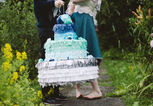 a creative and bold ombre fringe cake-shaped pinata wedding guest book from deep blue to silver is a very creative idea suitable for a big wedding