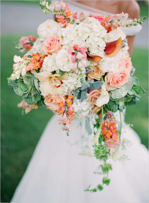 A beautiful super lush cascading wedding bouquet with blush roses, white hydrangeas, cabbage and cascading greenery for a spring or summer rustic wedding