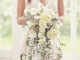 a heavenly airy and chic cascading wedding bouquet with white and pink blooms and greenery is a lovely idea for a spring or summer wedding