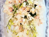 a charming cascading wedding bouquet of white orchids is a gorgeous idea for a tropical bride