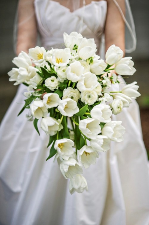 a fabulously elegant white tulip cascading wedding bouquet looks very refined and chic and will finish off your spring bridal look with style