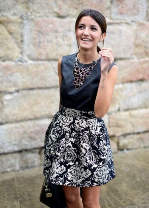 a black mini dress with a leather top and a floral skirt, a black bag and a statement necklace