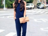 a navy jumpsuit, nude shoes and a neutral clutch, statement colorful earrings