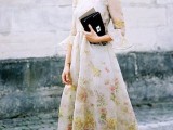 a floral midi dress with long sleeves, a high neckline, a black clutch and neon studded heels