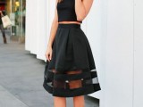 a chic black separate with a sleeveless top, a black A-line striped skirt and heels