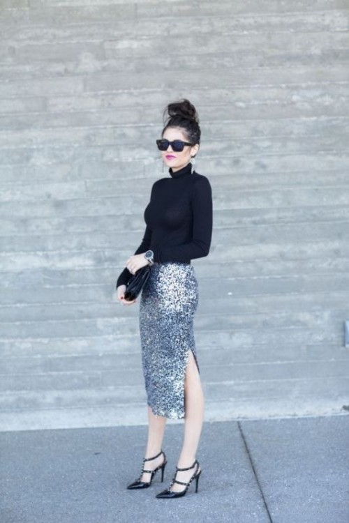 a silver midi skirt with a side slit, a black turtleneck, black shoes and a black clutch