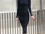 a black fitting dress with star embroidery and long sleeves and nude shoes
