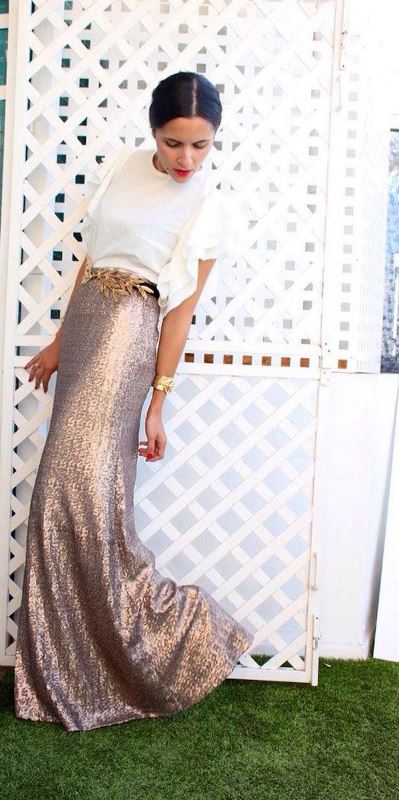 a white top with ruffled sleeves, a copper maxi skirt and an embellished belt