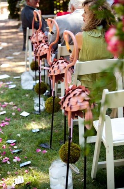 dusty pink flamingos, flower petals and moss balls for creating a cheerful and fun wedding aisle and ceremony space