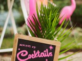 hot pink flamingos, tropical leaves and a chalkboard sign for decorating the space in a cool, bright and fun way and to give it a tropical feel to the venue