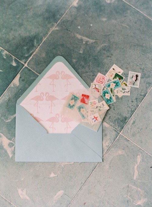 a pretty flamingo lining envelope with colorful cards and stamps will make your wedding invitation suites cooler and funnier