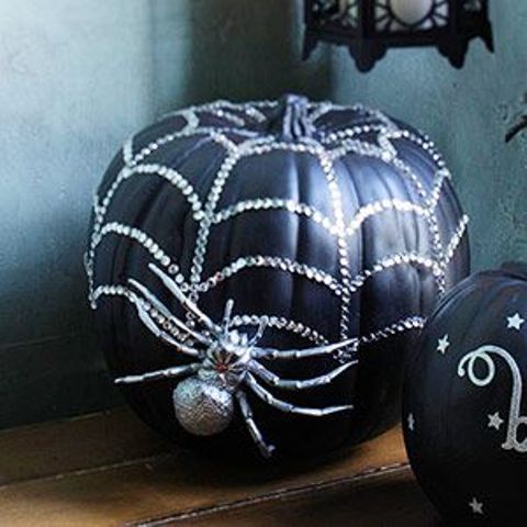 a black embellished pumpkin with a spider is a lovely idea for Halloween, it's ideal for styling the space for Halloween parties