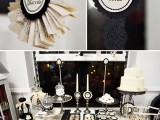 a black and white Hallowene bridal shower sweets table with various black and white sweets and signs is a cool idea for a Halloween bridal shower and it looks elegant