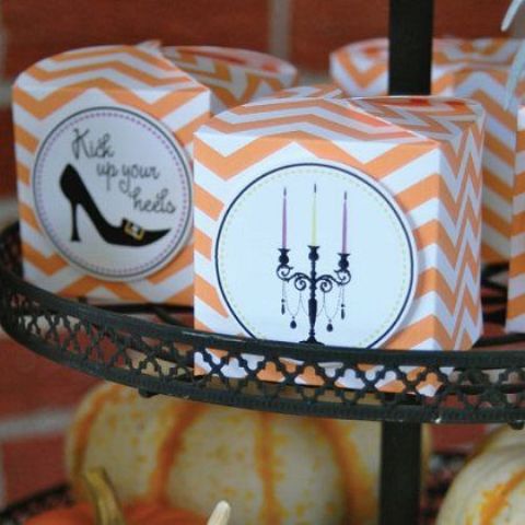 orange chevron printed boxes with various Halloween stuff are great to give them as favors at a Halloween bridal shower or wedding