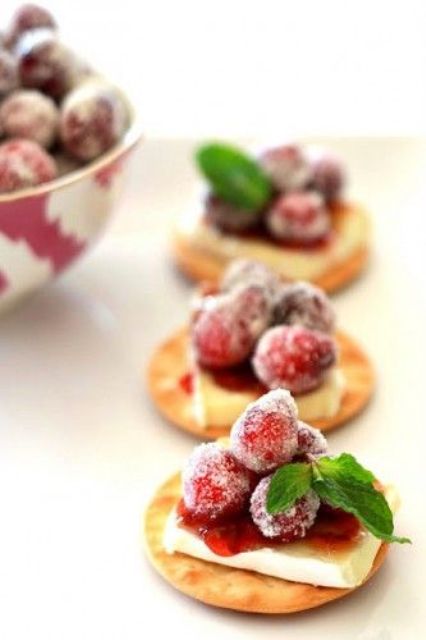 crackers with cream cheese, sugared cranberries and mint are a tasty idea suitable for vegetarians, too