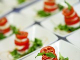 mini Caprese appetizers of cheese, tomatoes and basil plus balsamic are delicious