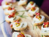 mini appetizers of toasts, cheese and sun dried tomatoes plus herbs will please both carnivores and vegetarians