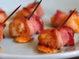 bacon slices wrapped and filled with cheese and eggs are a hearty and cool winter wedding appetizer