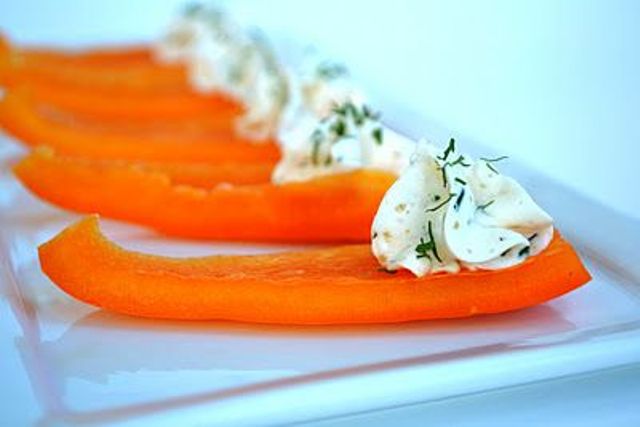A vegan winter wedding appetizer of pepper slices and cream cheese with herbs will please carnivores too