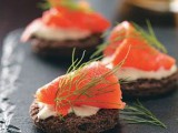 toasts with cream cheese and salmon and herbs on top are an exquisite and delicious appetizer idea