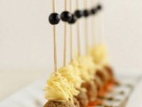 meatballs, spaghetti and olives on skewers are amazing and budget-friendly winter wedding appetizers