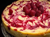 a swirl raspberry wedding cheesecake topped with fresh raspberries is a crowd-pleasing idea that tastes amazing