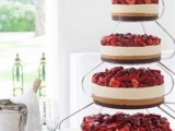 an assortment of delicious wedding cheesecakes in various sizes with fresh strawberries on top