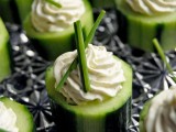 fresh cucumbers topped with dip and herbs are a simple and delicious idea for a spring wedding