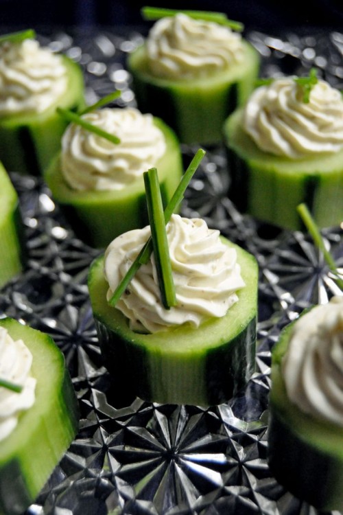 fresh cucumbers topped with dip and herbs are a simple and delicious idea for a spring wedding
