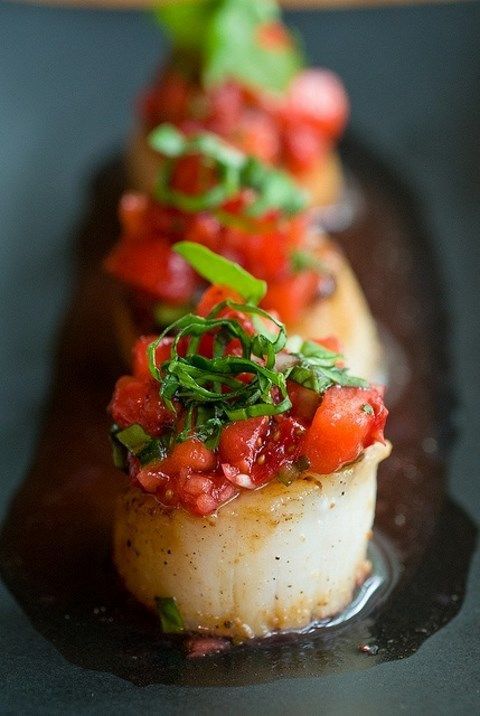 scallops with fresh tomato and herb salad on top is a very exquisite idea for any wedding including a spring one